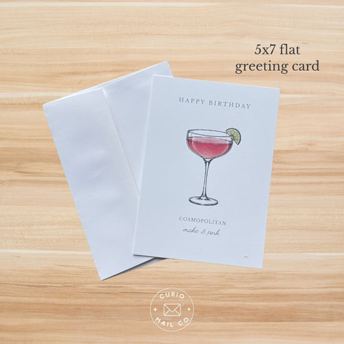 Happy Birthday Cosmopolitan Card on a wood background