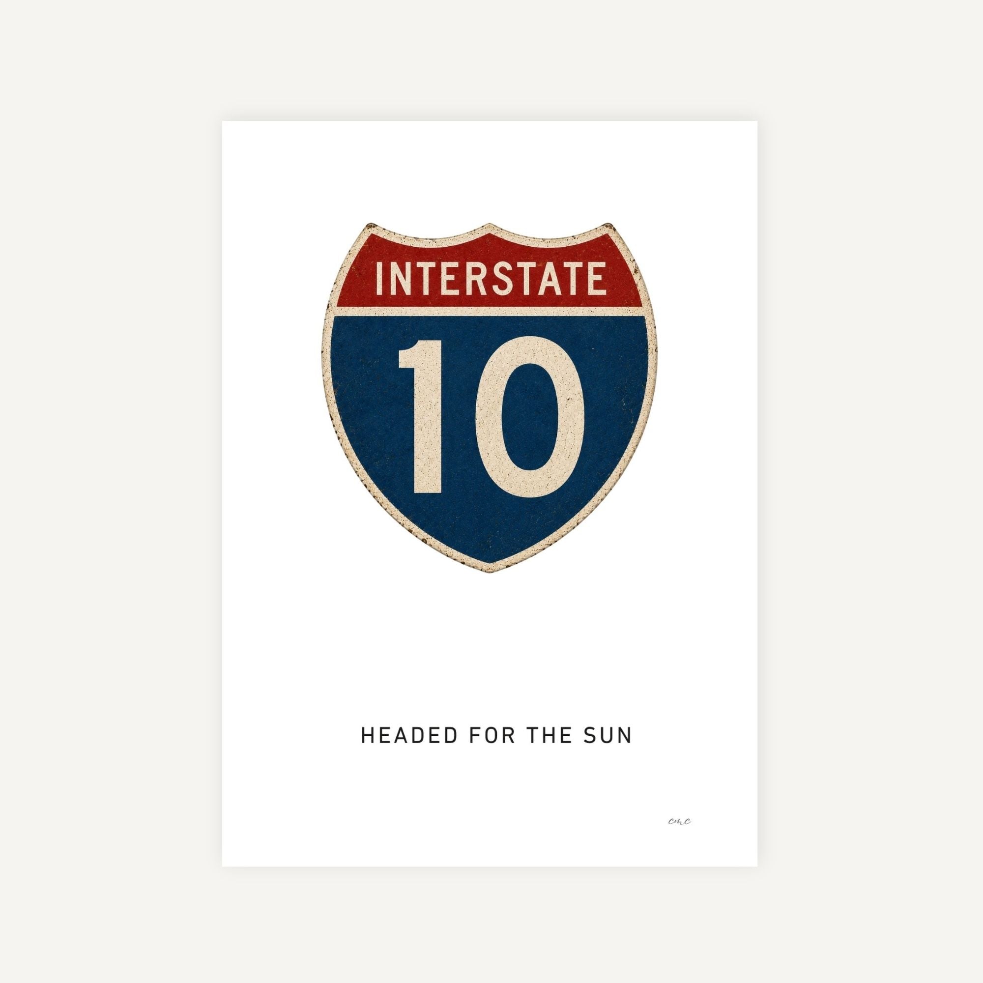 Interstate 10 road sign with text 'Headed for the Sun' on a white background