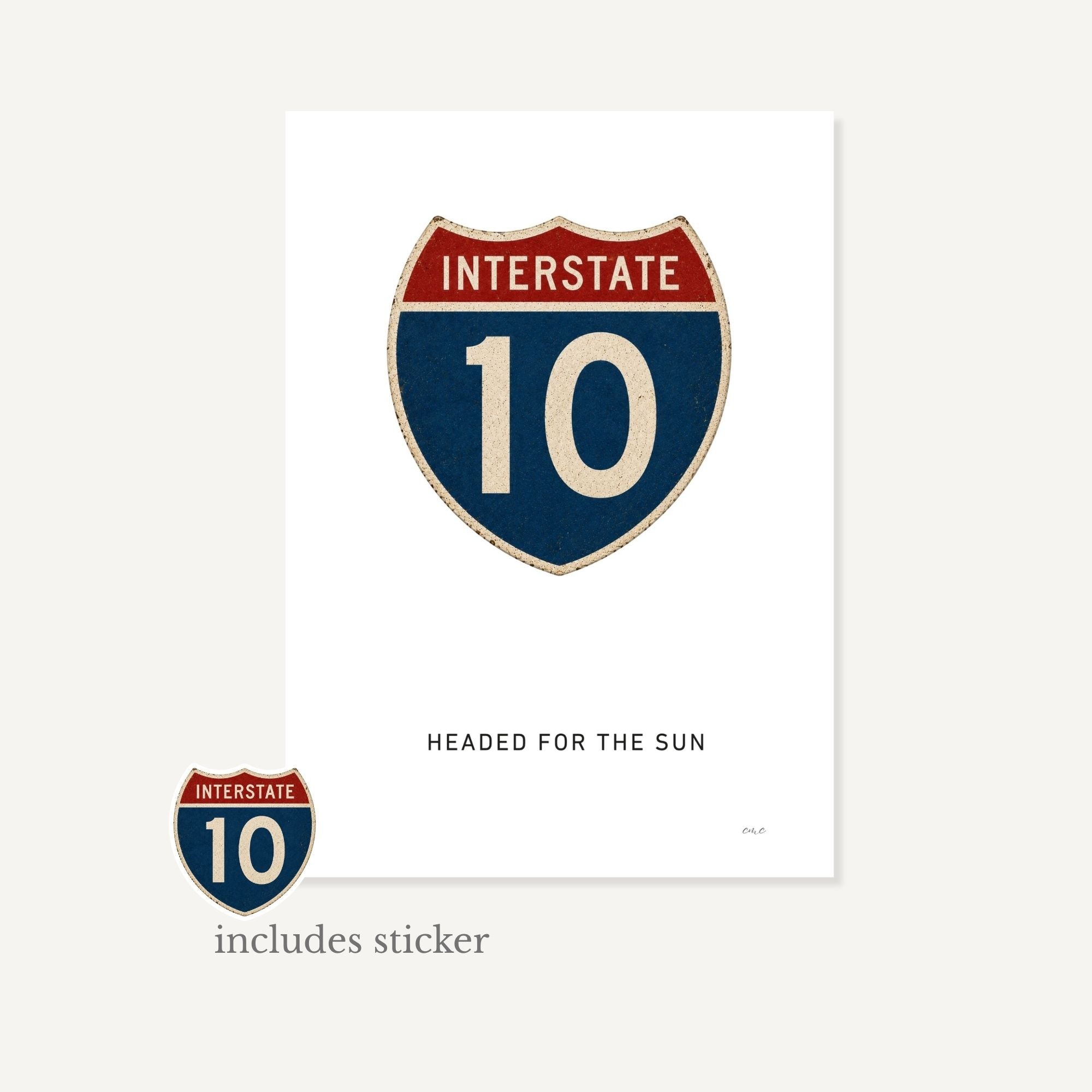 Interstate 10 sign with a sticker on a white background