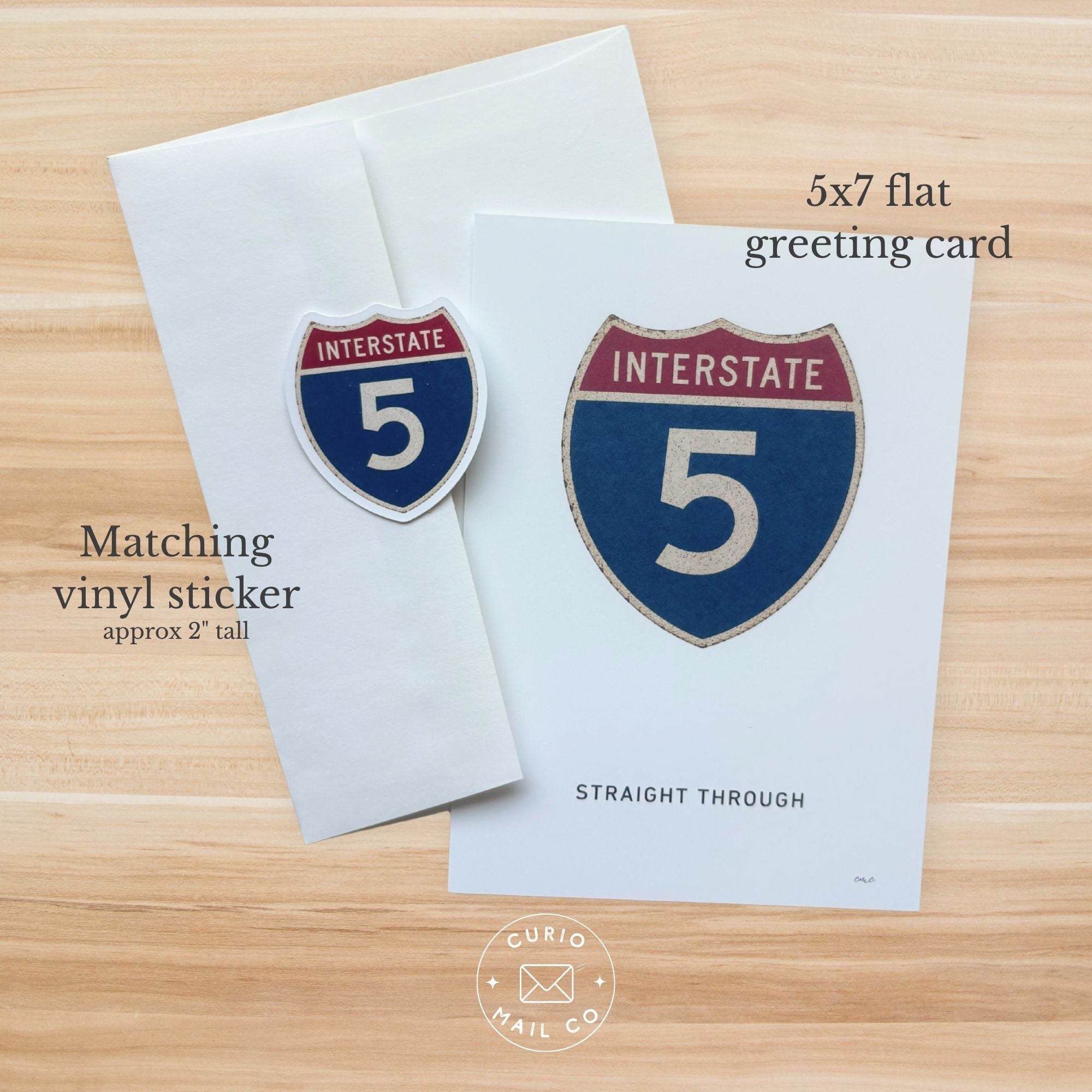5x7 flat greeting card with matching vinyl sticker on a wooden surface, featuring 'Curio Mail Co' branding.