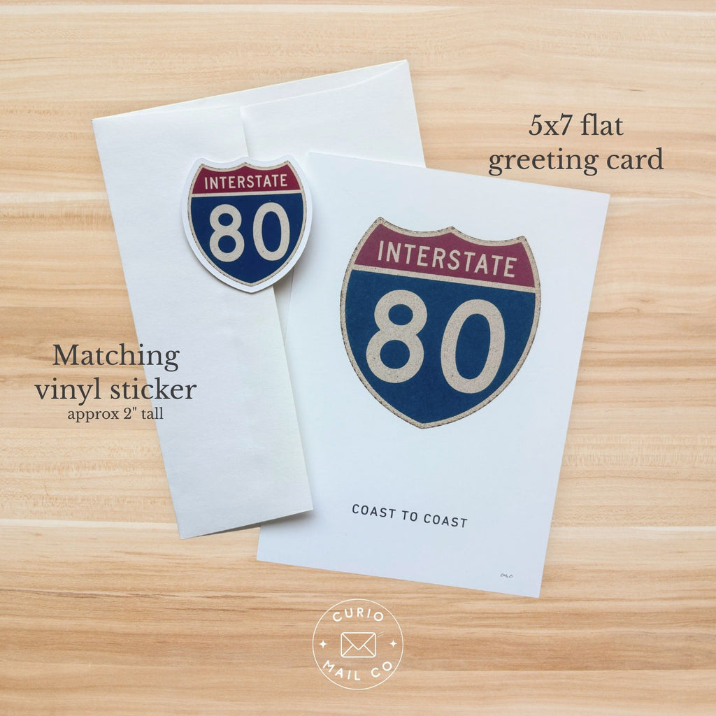 5x7 flat greeting card and matching vinyl sticker with Interstate 80 design on a wooden surface.