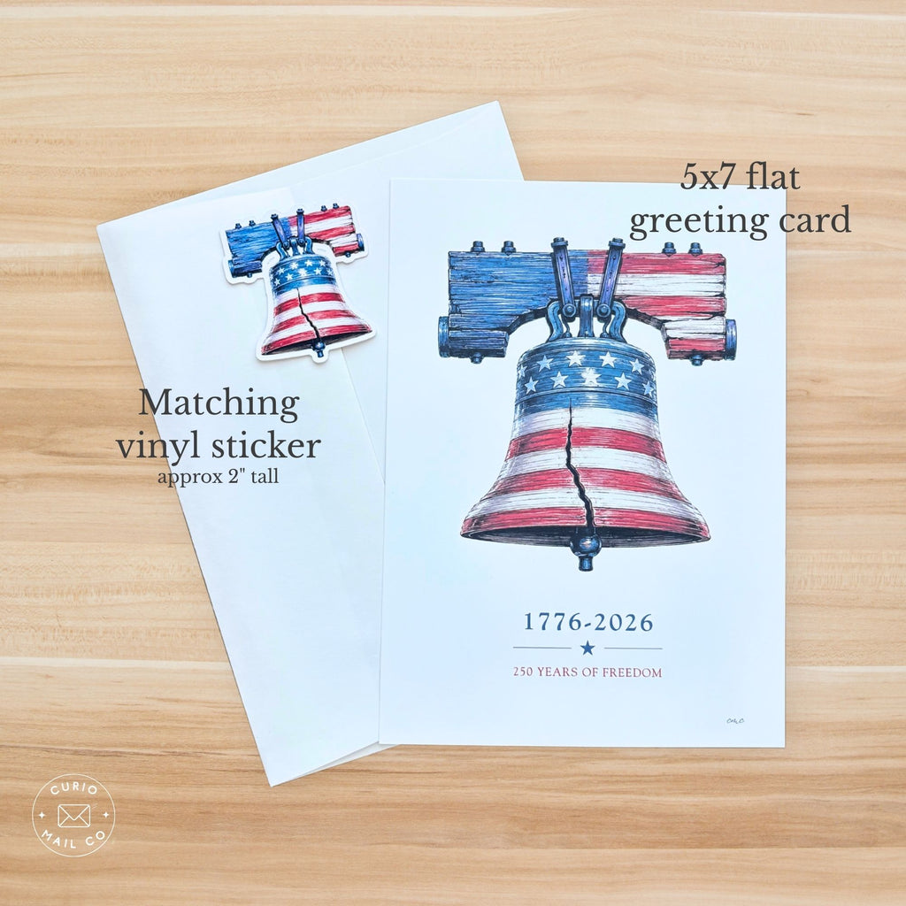 Greeting card with Liberty Bell design and text on a wooden surface