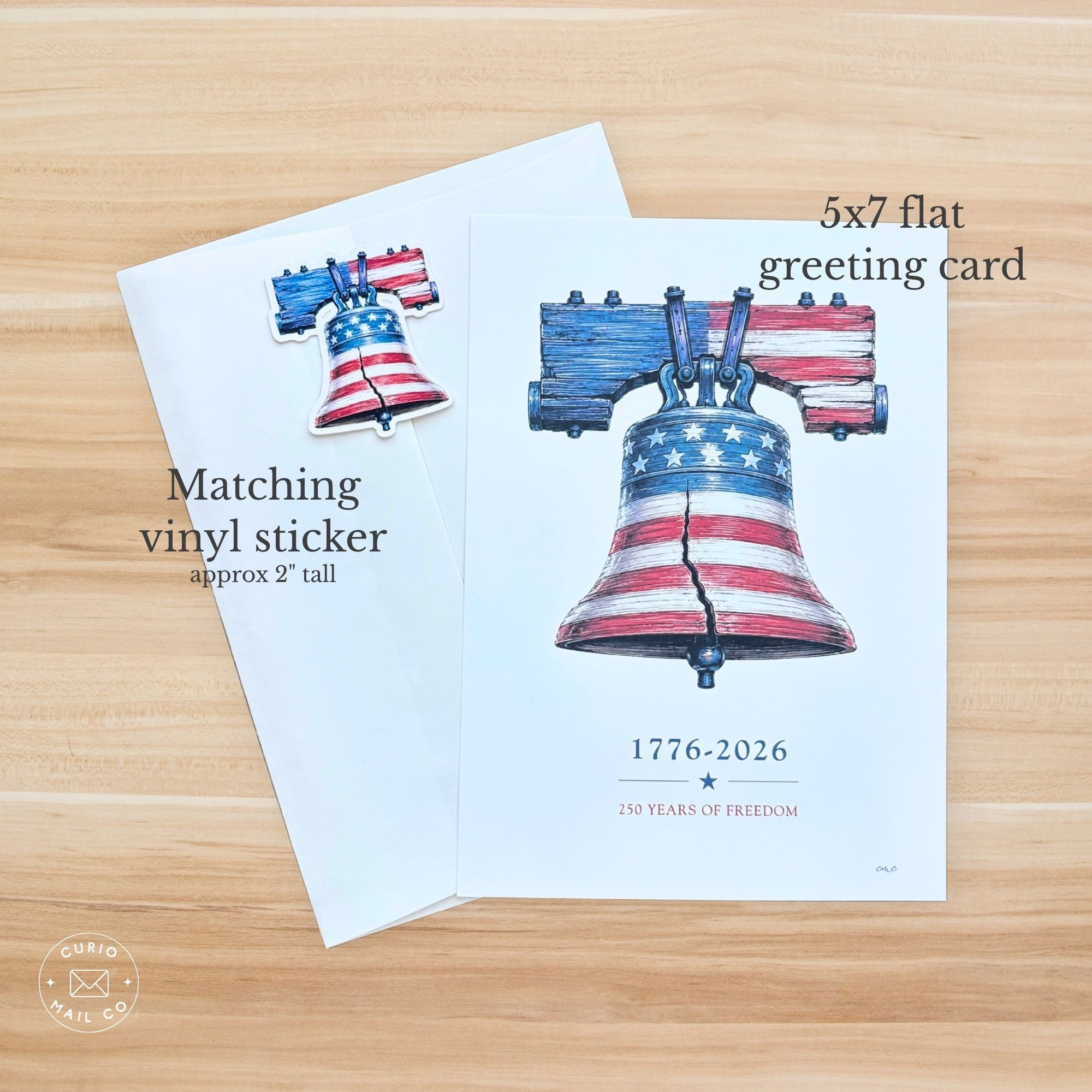 Greeting card with Liberty Bell design and text on a wooden surface