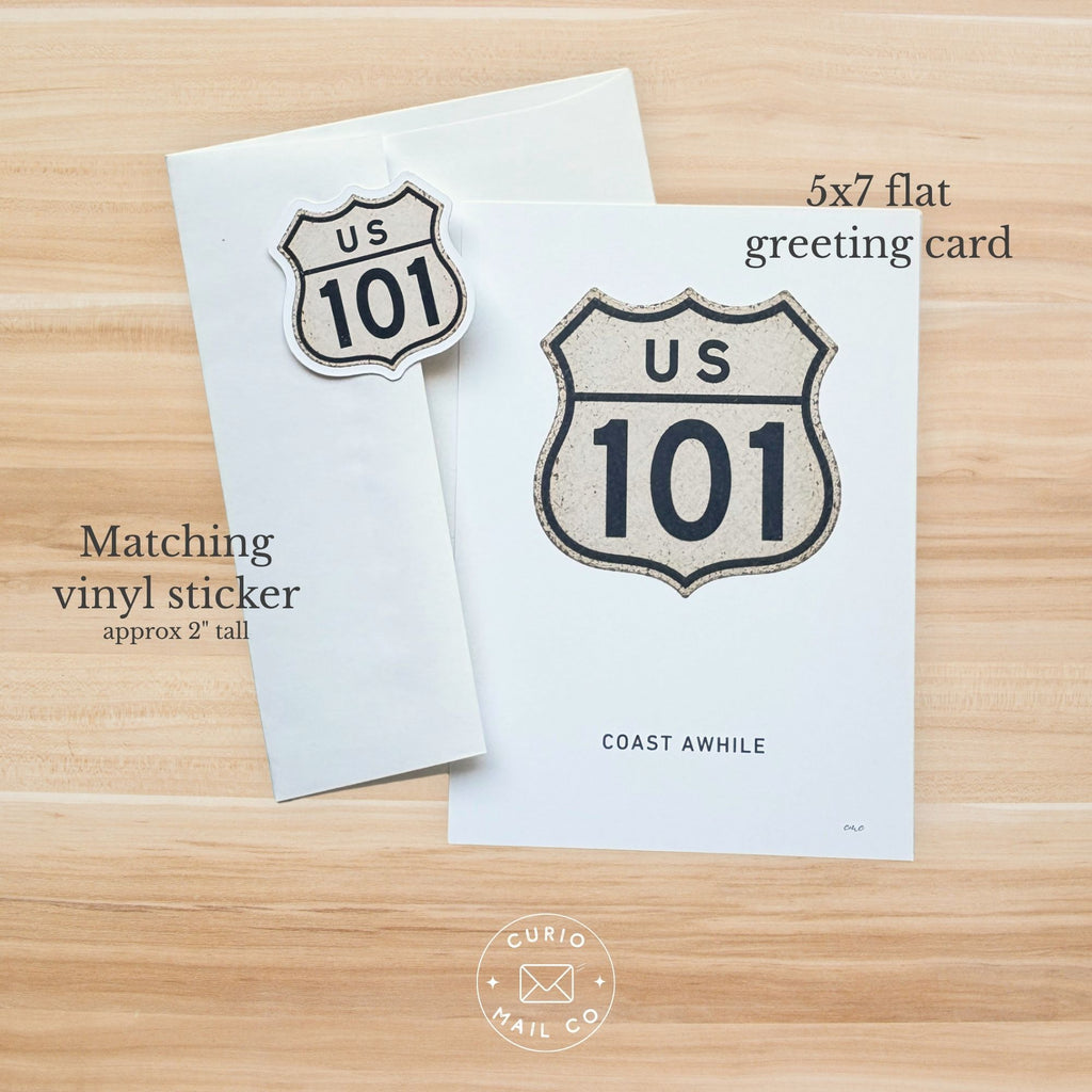 5x7 flat greeting card with US 101 design and matching vinyl sticker on a wooden surface.