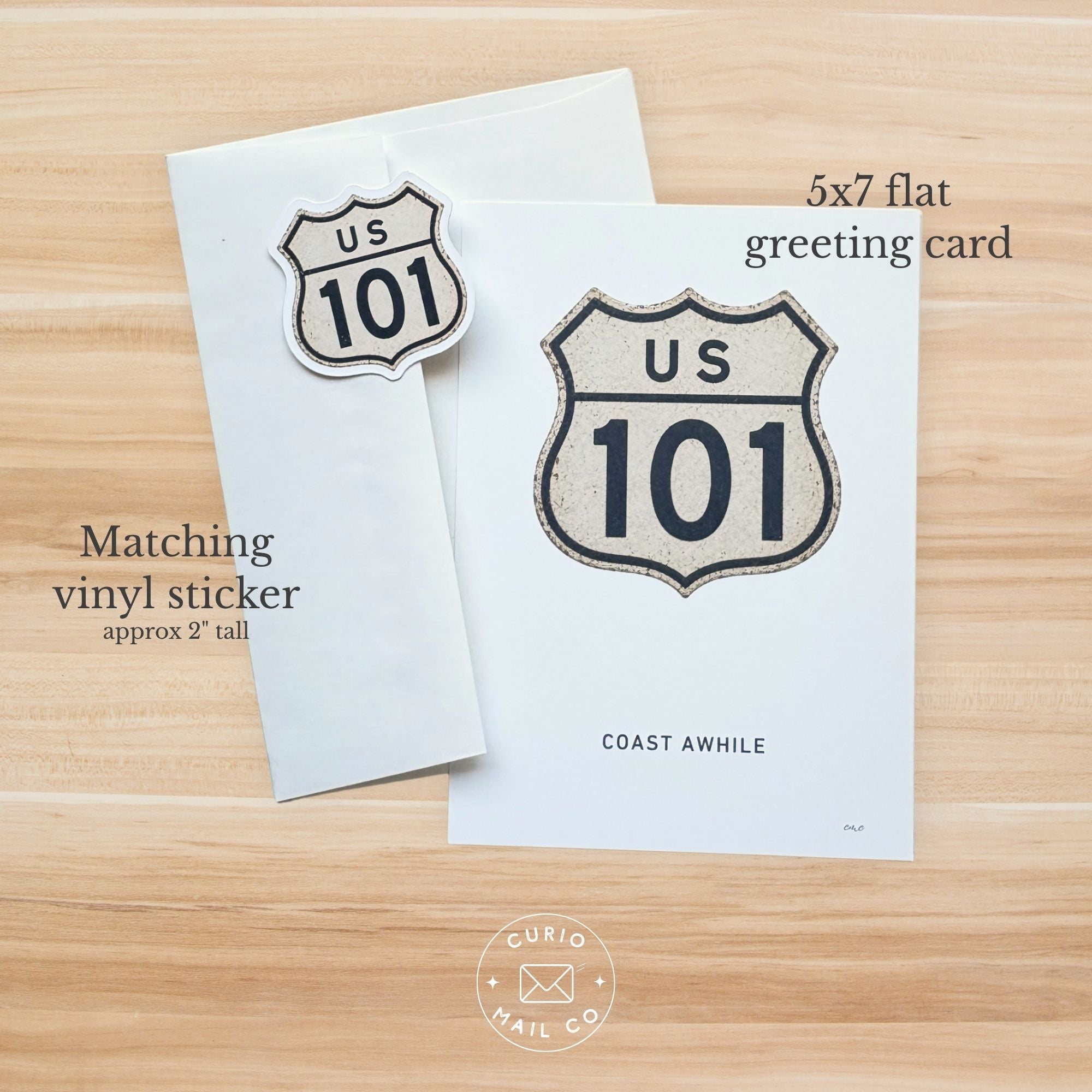5x7 flat greeting card with US 101 design and matching vinyl sticker on a wooden surface.