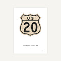 Vintage-style US Route 20 sign with 'The Road Goes On' text on a white background
