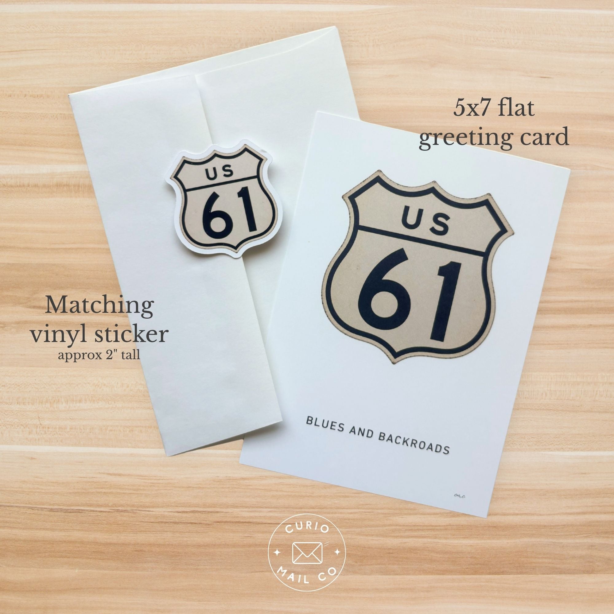 5x7 flat greeting card and matching vinyl sticker with US 61 design on a wooden surface.