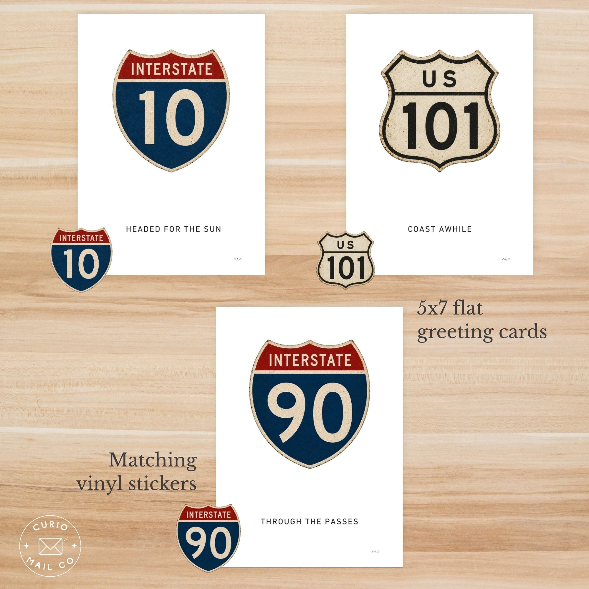 Greeting cards with highway route symbols on a wooden surface
