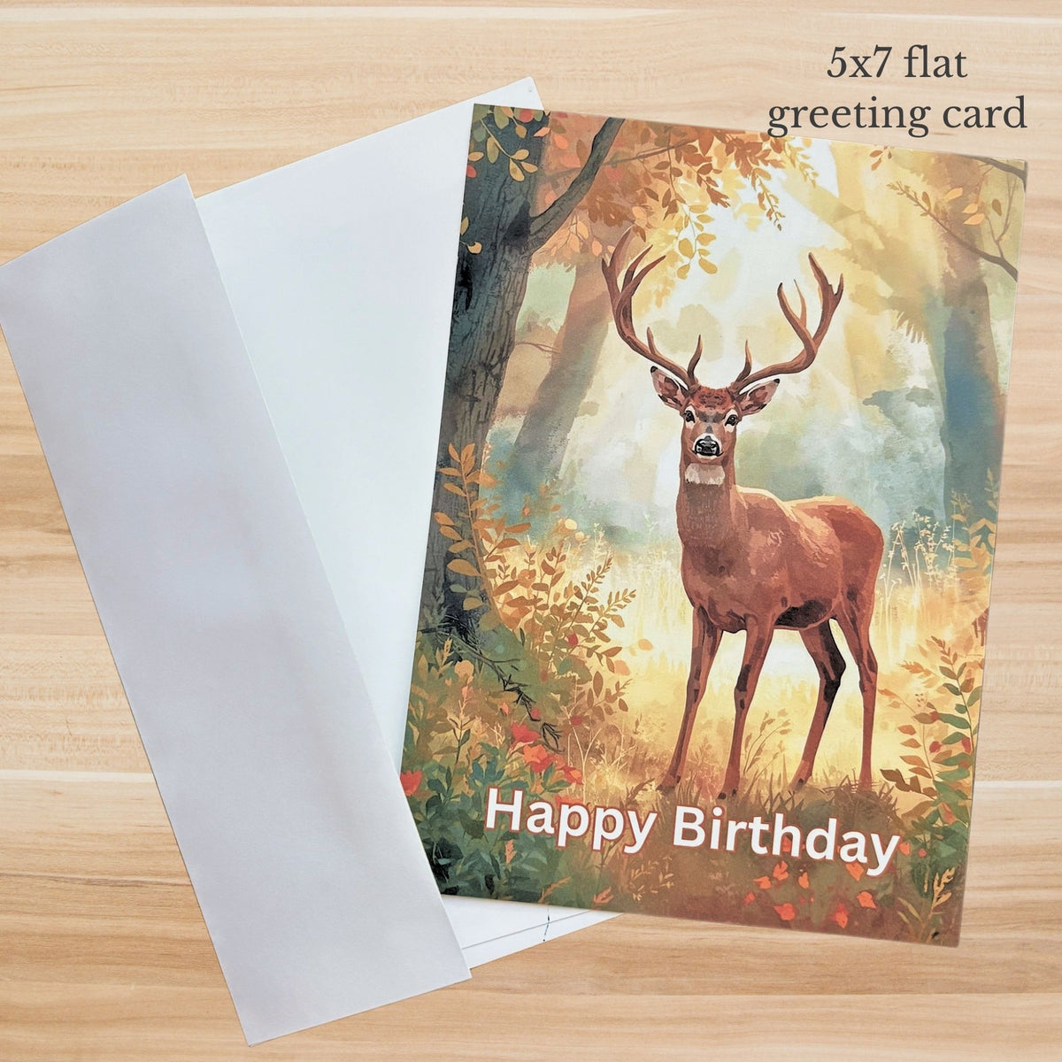 Woodland deer birthday card with Happy Birthday text in a warm forest setting in front of an envelope