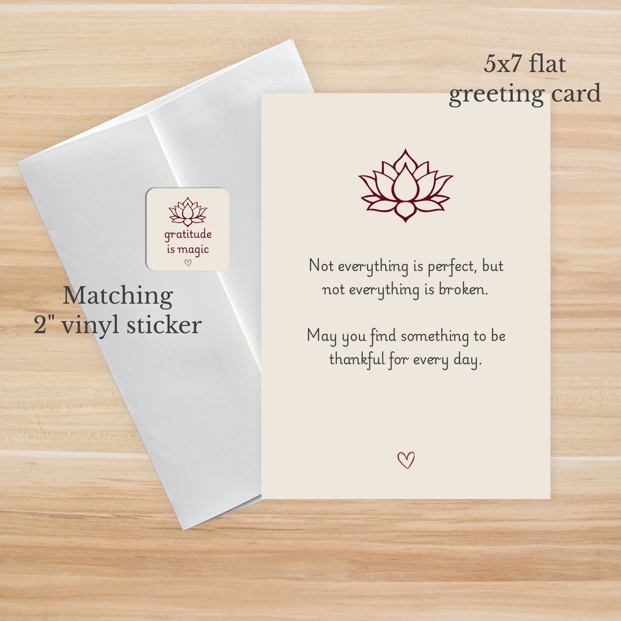 5x7 flat greeting card with lotus design and text on a wooden surface, matching 2" vinyl sticker.