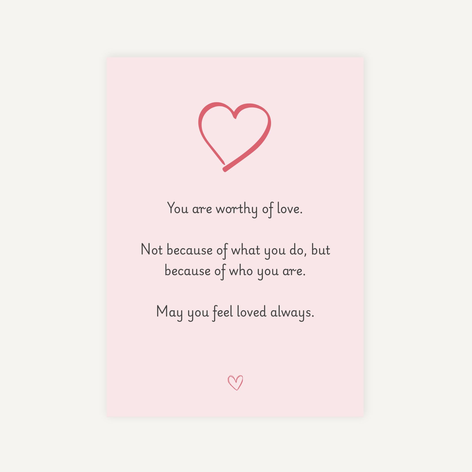 Motivational quote with a heart symbol on a pink background