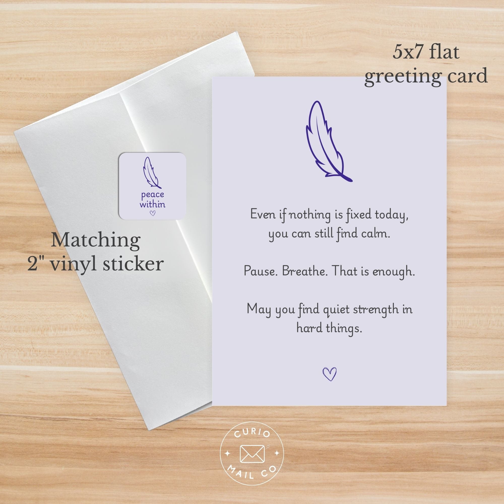 Greeting card with feather design and text on a wooden surface, featuring matching vinyl sticker.