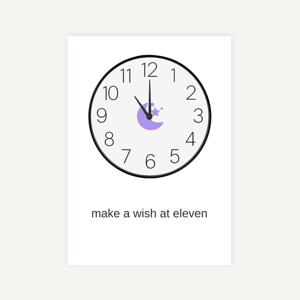 Clock with a hand on the number 11 and text 'make a wish at eleven' on a white background