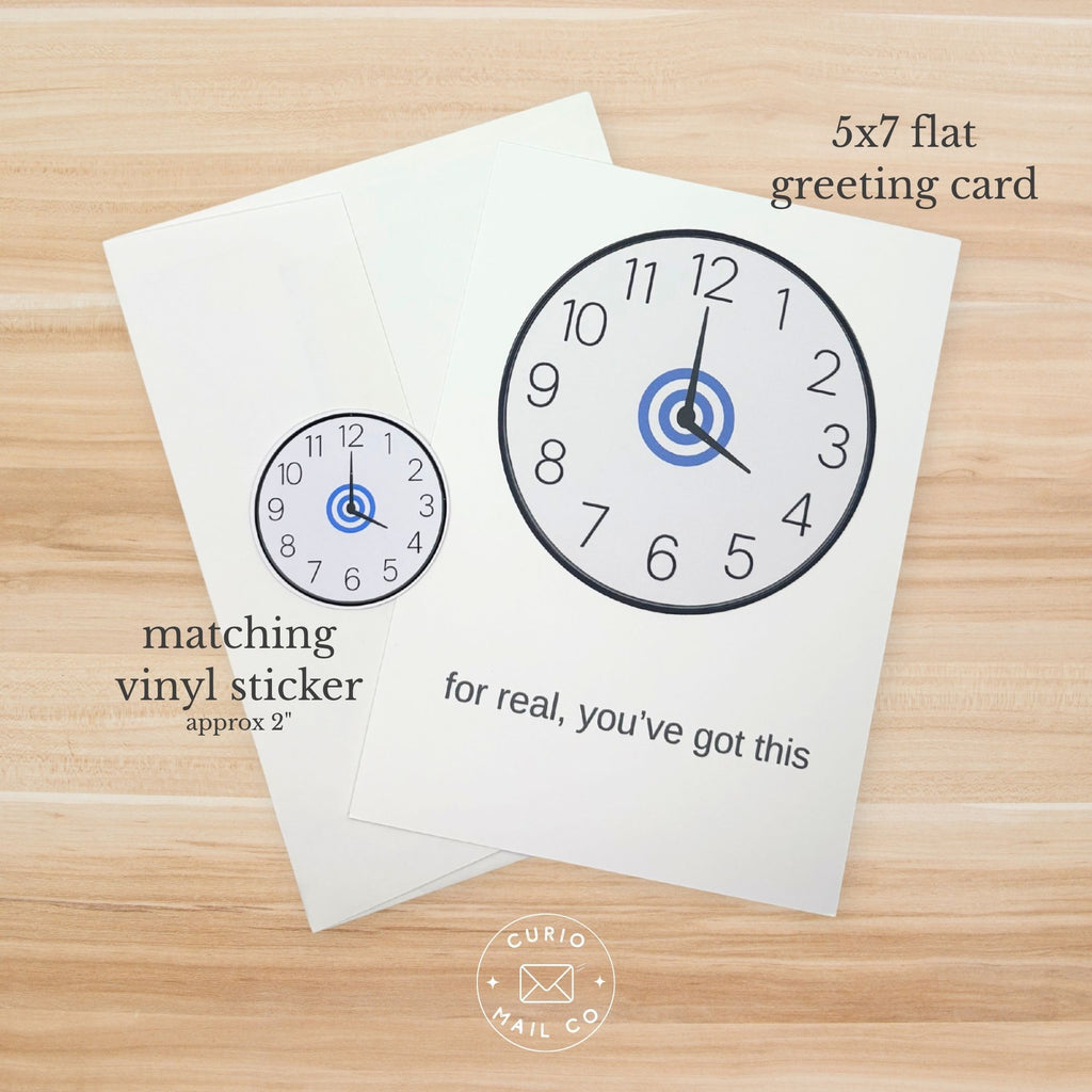 5x7 flat greeting card with clock design and matching vinyl sticker on a wooden surface.