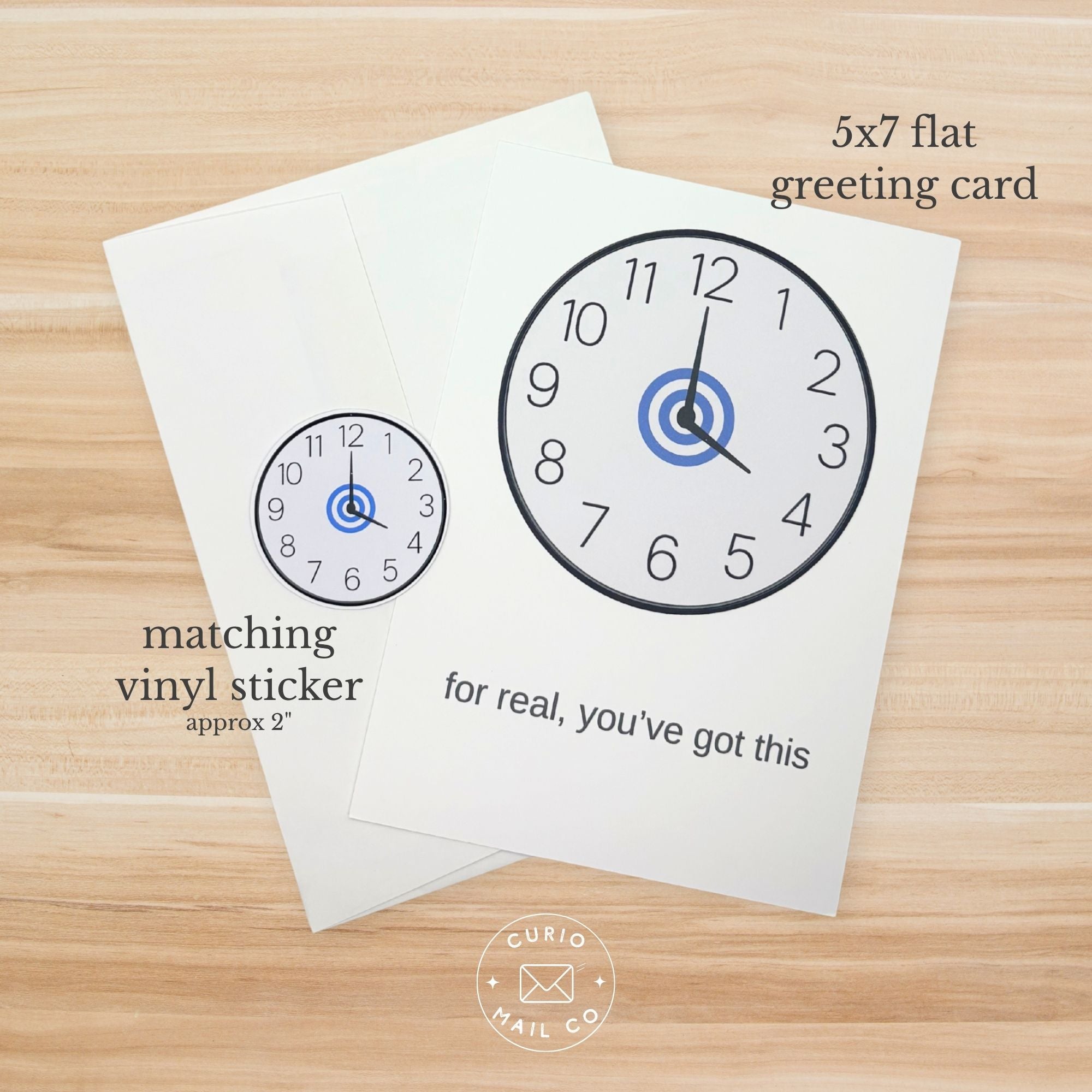 5x7 flat greeting card with clock design and matching vinyl sticker on a wooden surface.