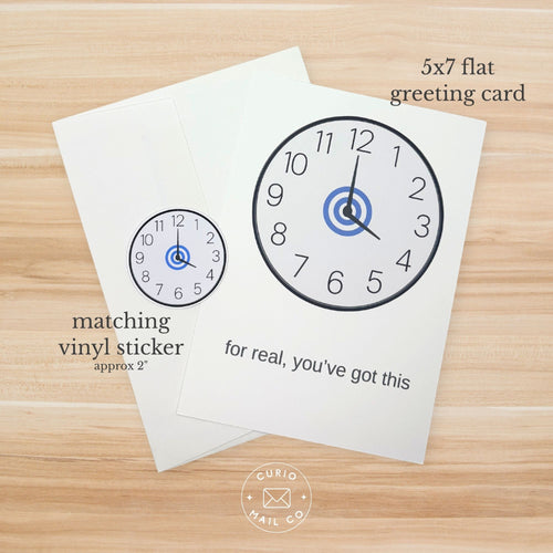 5x7 flat greeting card with clock design and matching vinyl sticker on a wooden surface.