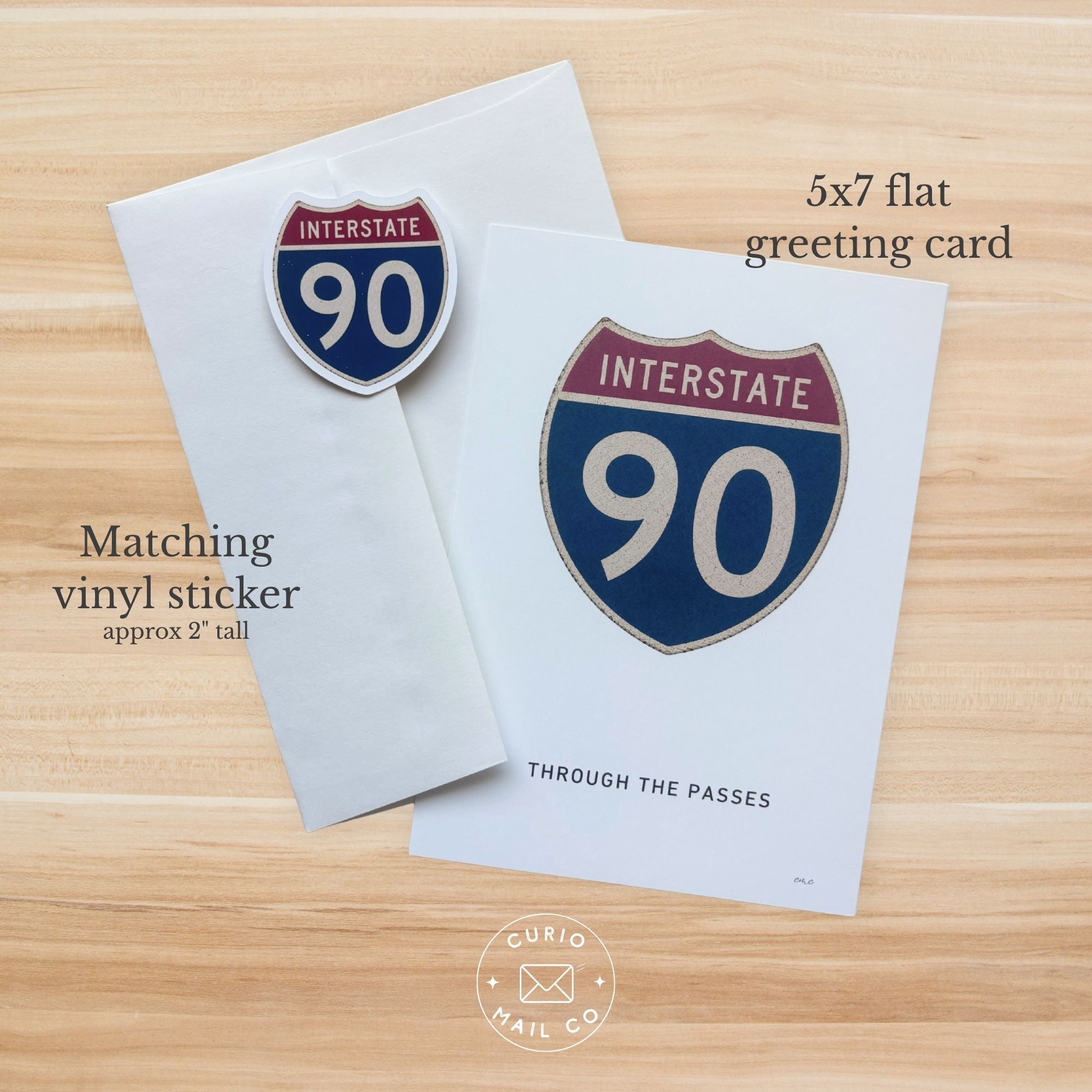 5x7 flat greeting card with Interstate 90 design on a wooden surface
