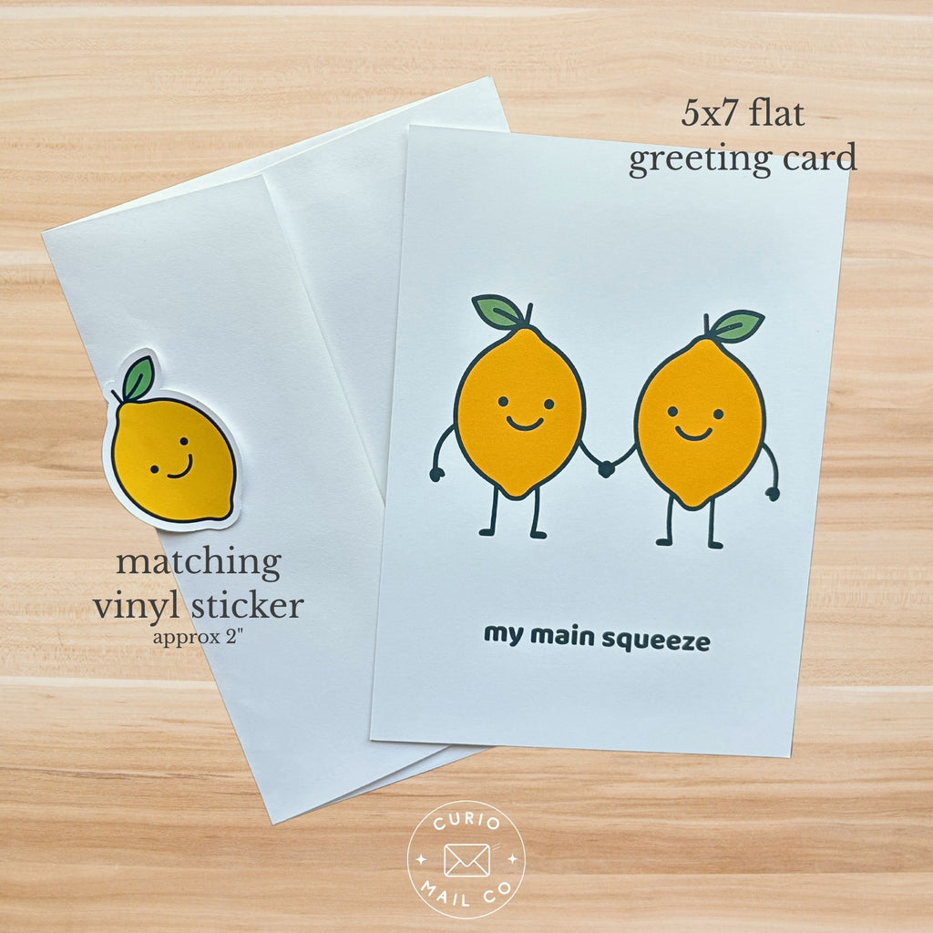 Greeting card with lemon design and matching vinyl sticker on a wooden surface
