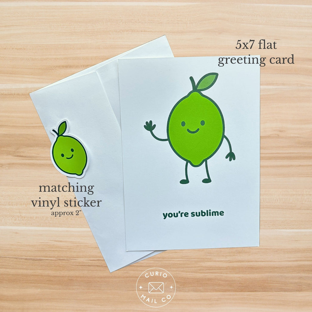 Greeting card with a lime illustration and matching vinyl sticker on a wooden surface.