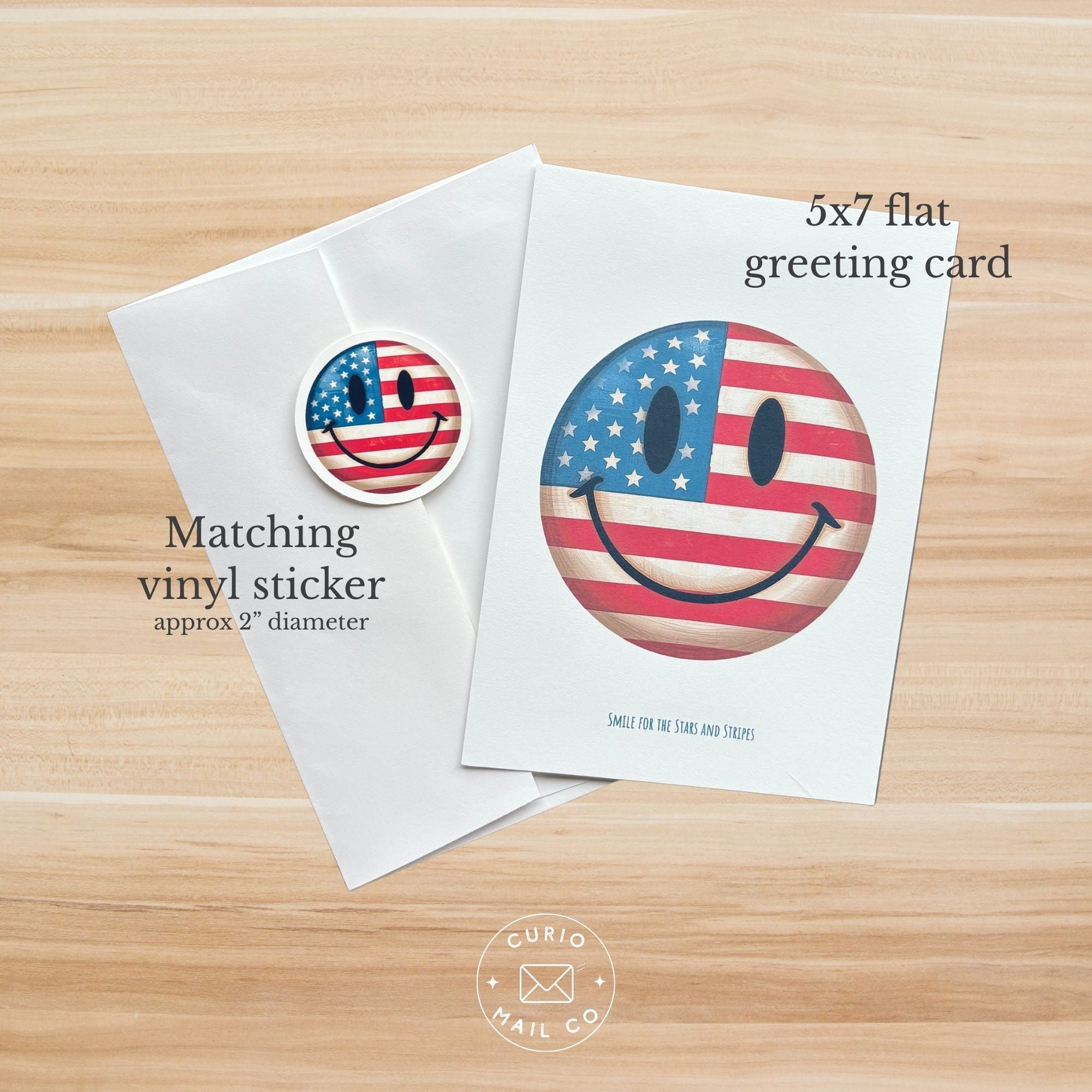 5x7 flat greeting card and matching vinyl sticker with American flag design on a wooden surface, Curio Mail Co logo visible.