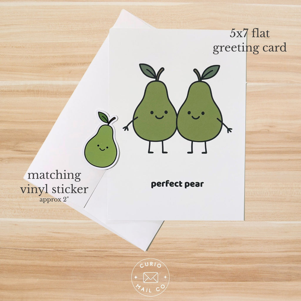 Greeting card with cartoon pears and matching vinyl sticker on a wooden surface