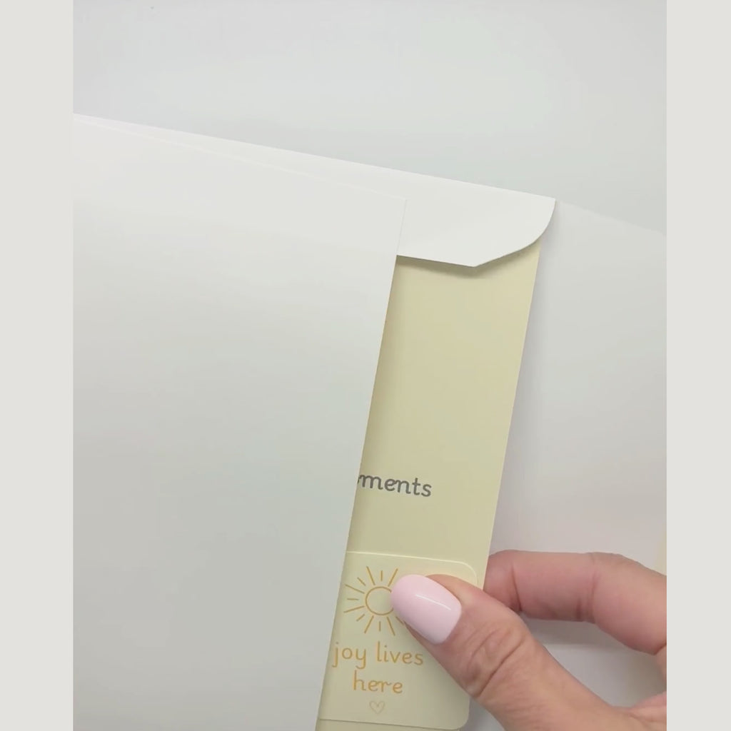 video showing a blessing card and sticker being pulled from an envelope