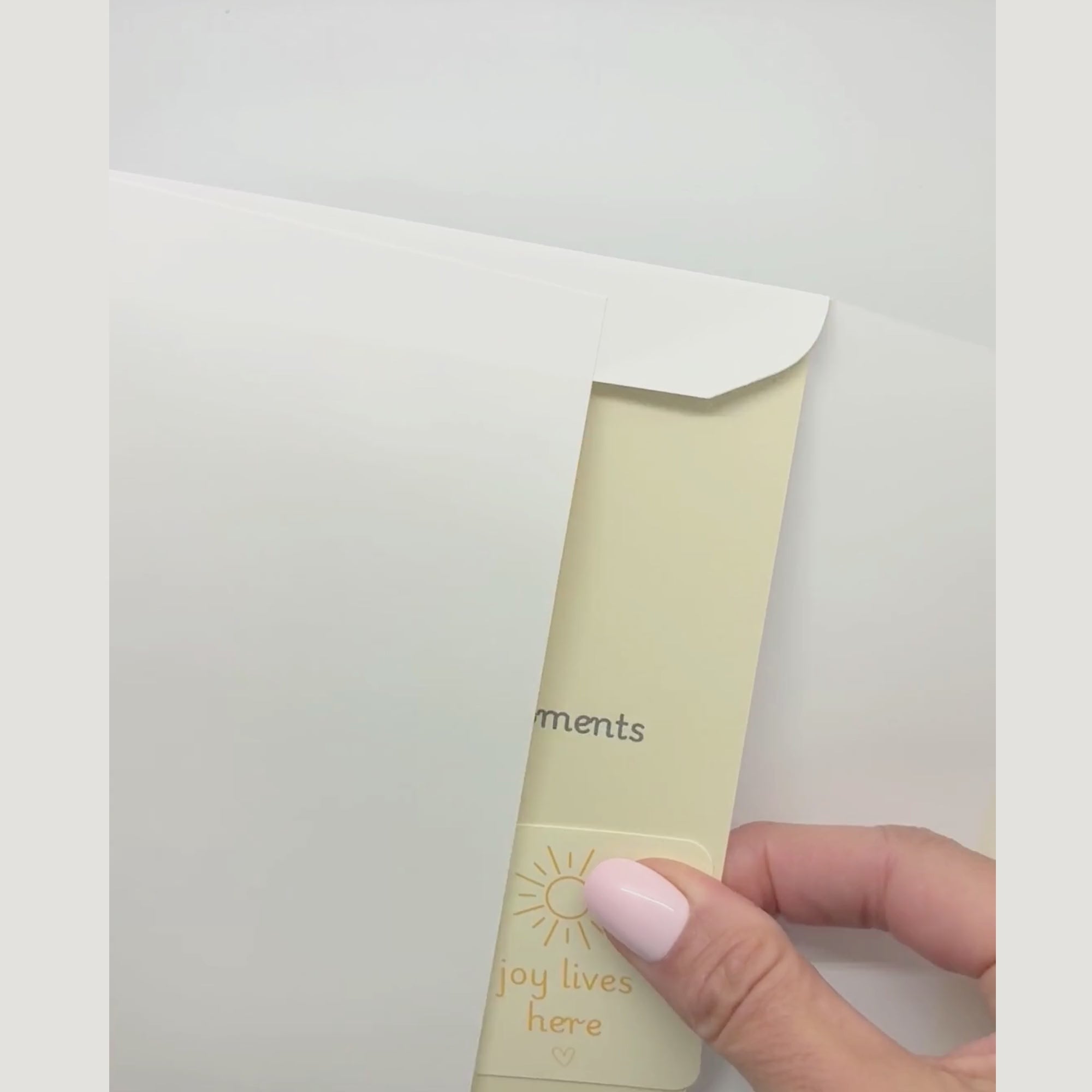 video showing a blessing card and sticker being pulled from an envelope