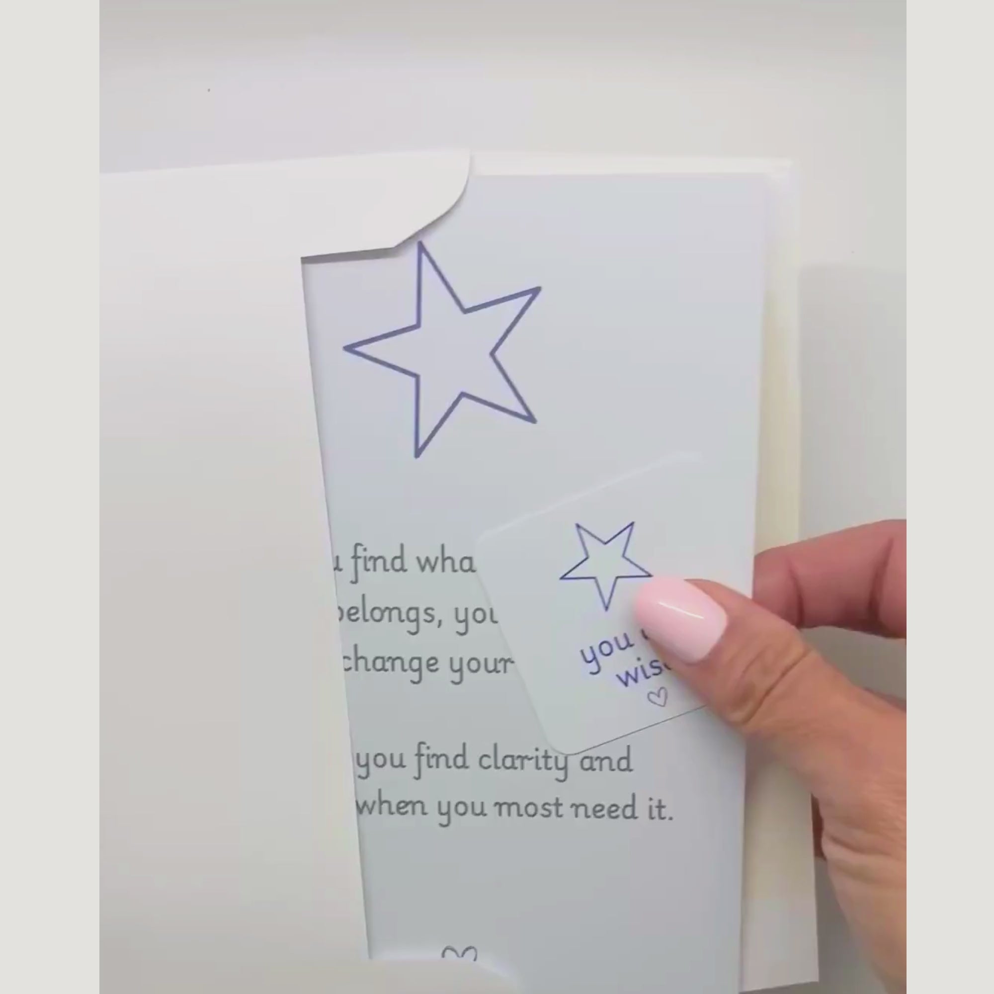 video showing a blessing card and sticker being pulled from an envelope