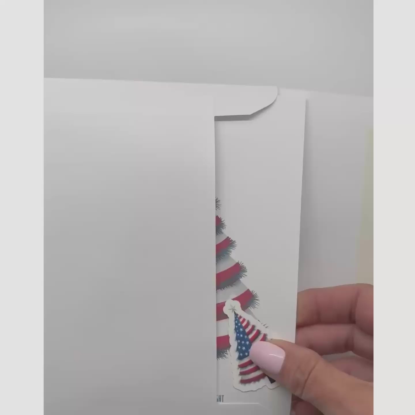 video showing the patriotic card and sticker being removed from an envelope