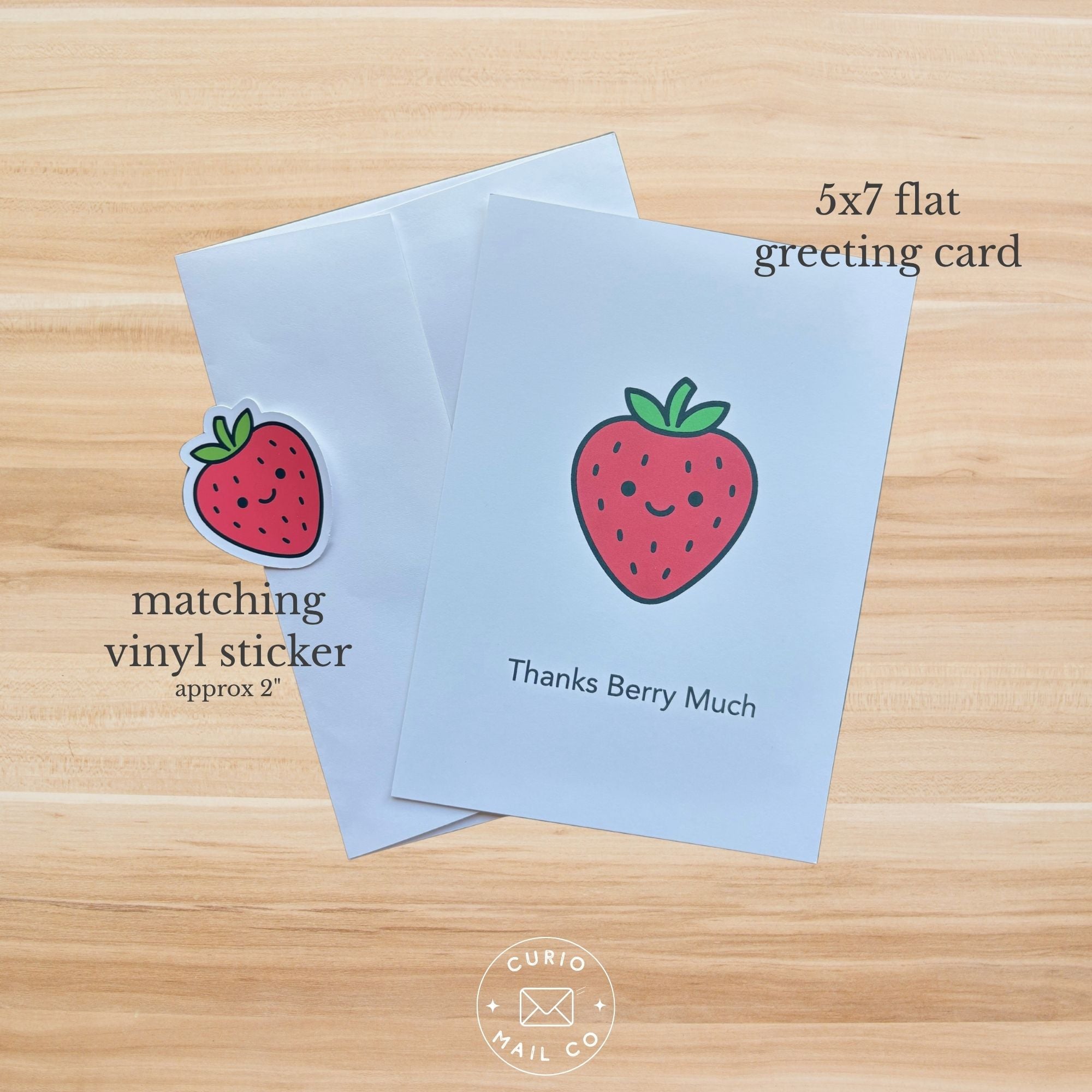 5x7 flat greeting card with strawberry design on a wooden surface, featuring 'Curio Mail Co' branding.