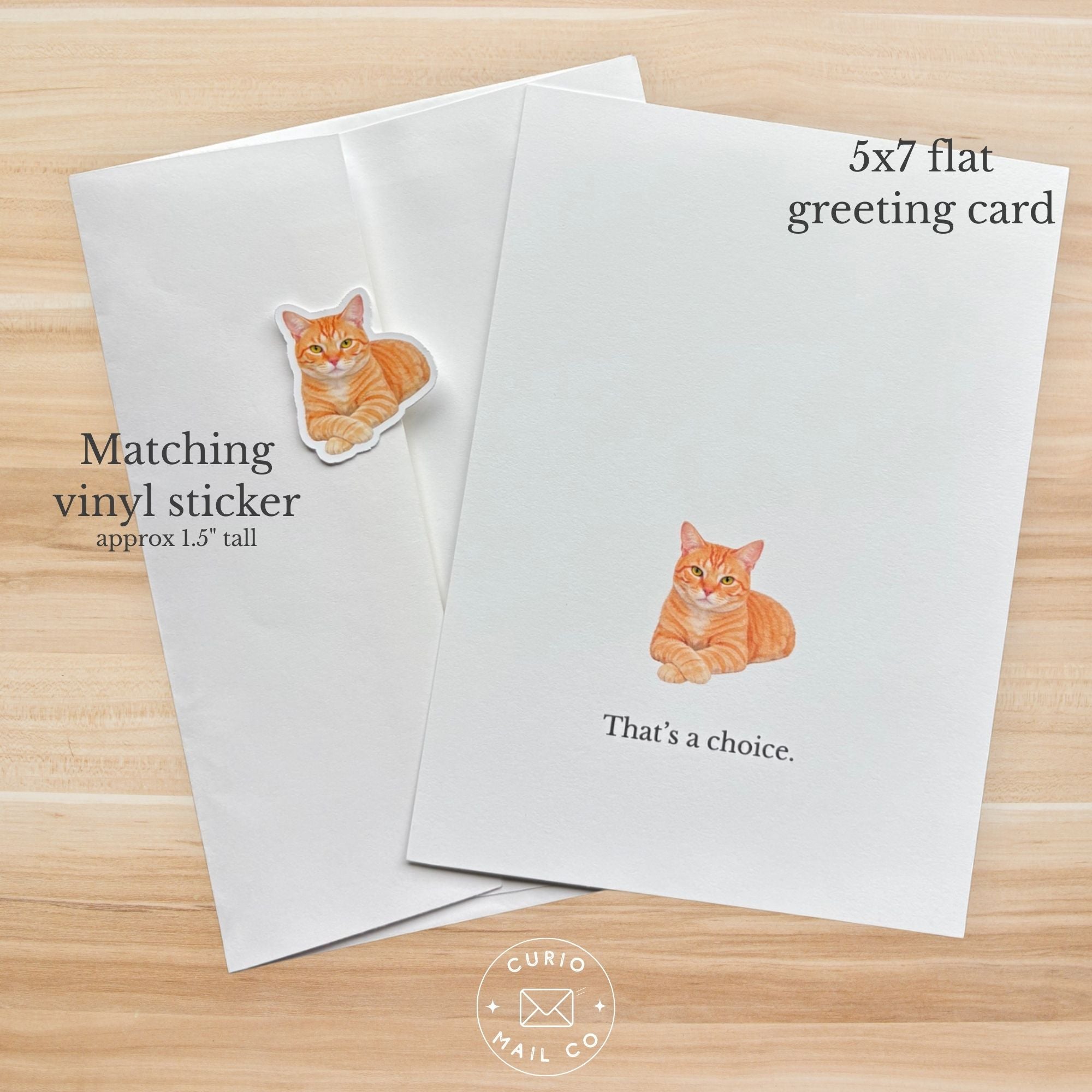 5x7 flat greeting card with cat illustration and matching vinyl sticker on a wooden surface.