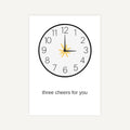 Clock with a yellow flower on the hour hand against a white background with 'three cheers for you' text.