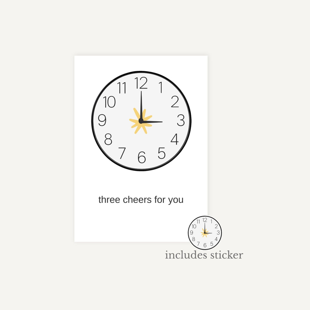 Decorative wall clock with sun design and text 'three cheers for you' on a white background.